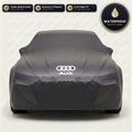Black Audi outdoor car cover, waterproof and custom fit, with printed Audi logo