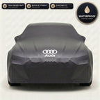 Black Audi outdoor car cover, waterproof and custom fit, with printed Audi logo
