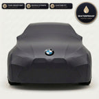 Black BMW outdoor car cover, waterproof and custom fit, with printed BMW logo