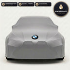 Gray BMW outdoor car cover, waterproof and custom fit, with printed BMW logo