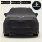 Black Cadillac outdoor car cover, waterproof and custom fit, with printed Cadillac logo