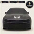 Black Dodge outdoor car cover, waterproof and custom fit, with printed Dodge logo