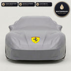 Gray Ferrari outdoor car cover, waterproof and custom fit, with printed Ferrari logo