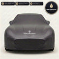 Black Maserati outdoor car cover, waterproof and custom fit, with printed Maserati logo