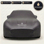 Black Maserati outdoor car cover, waterproof and custom fit, with printed Maserati logo