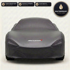Black McLaren outdoor car cover, waterproof and custom fit, with printed McLaren logo
