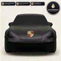 Black Porsche outdoor car cover, waterproof and custom fit, with printed Porsche logo
