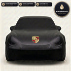 Black Porsche outdoor car cover, waterproof and custom fit, with printed Porsche logo