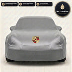 Gray Porsche outdoor car cover, waterproof and custom fit, with printed Porsche logo