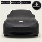 Black Tesla outdoor car cover, waterproof and custom fit, with printed Tesla logo